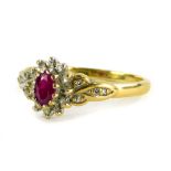 A 9ct gold floral cluster ring, set with various CZ stones and a central ruby, in a white gold