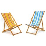 Two vintage deck chairs, one with orange, red, yellow and green fabric, the other with blue, green