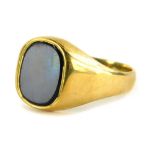 A 9ct gold gents signet ring, set with oval black agate, on a rectangular ring head, on a plain