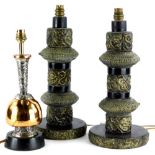 A pair of Indian brass table lamps, each modelled with scrolls, 'S' shaped motifs, and applied