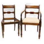 A 19thC mahogany elbow chair, with a panelled back, drop in seat and shaped arms on turned