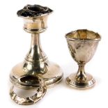 A George V silver squat candlestick, with loaded base, Birmingham 1919, 10cm high, and a silver