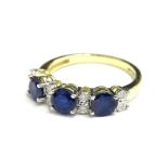 A 9ct gold sapphire and diamond dress ring, the round brilliant cut sapphires totalling approx 1.