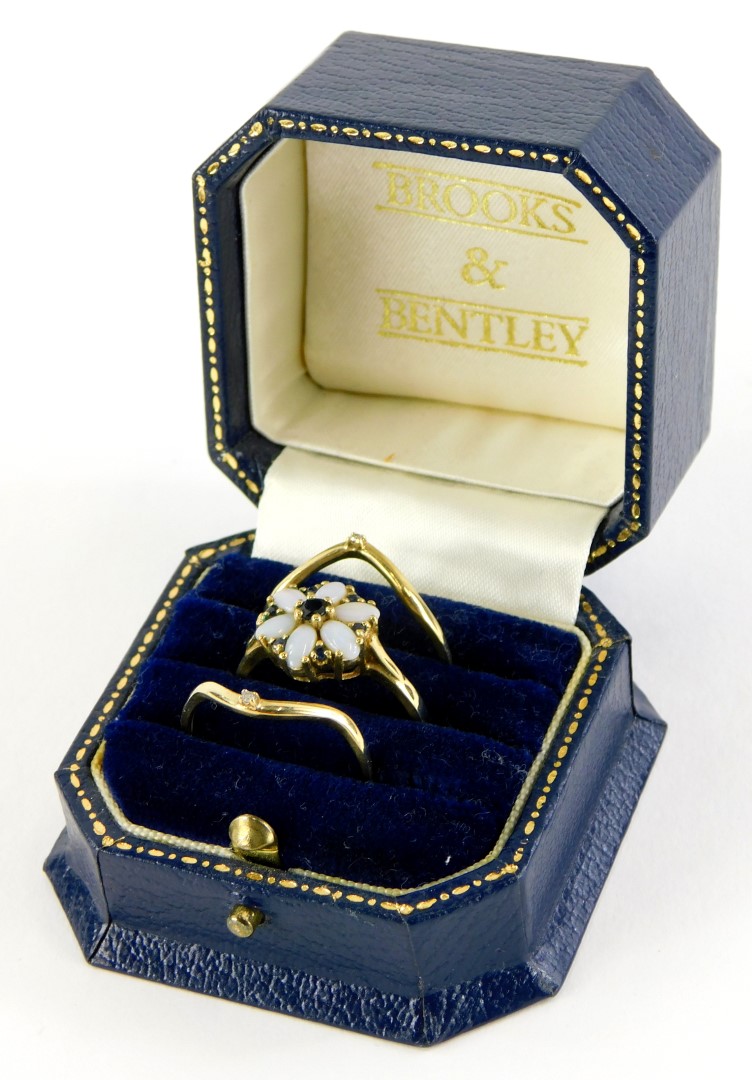 A Brooks and Bentley The Opal Dream Triple ring, with two wishbone design 9ct rings, each set with