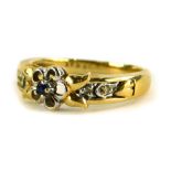 A 9ct gold dress ring, with central floral design set with single sapphire, in a silvered colour
