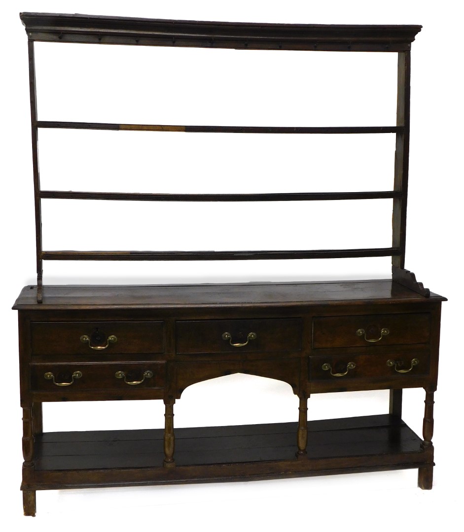 A late 18th/early 19thC oak dresser, the associated raised back with three plate shelves, the base