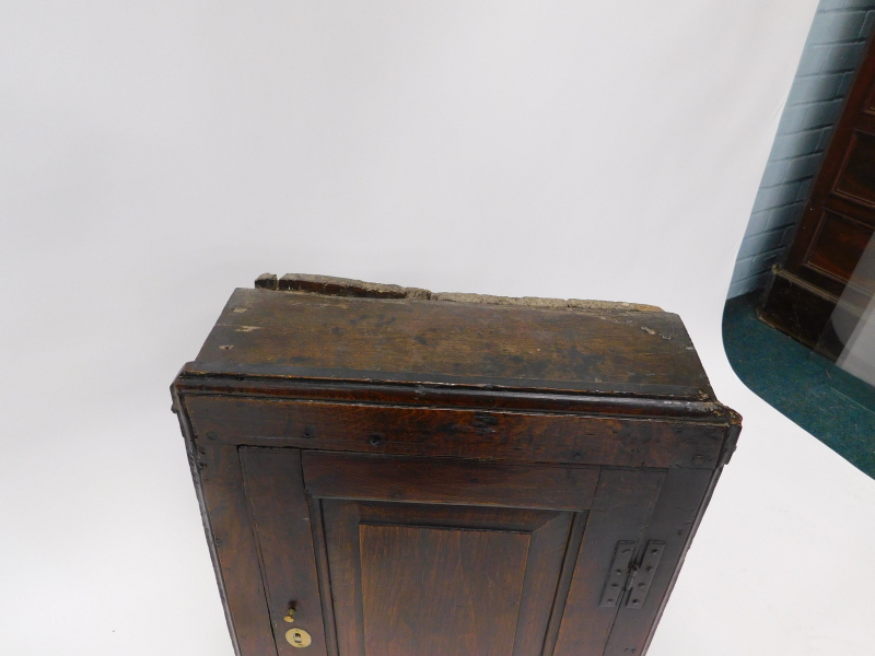 A late 17th/early 18thC oak wall cupboard, the top with a moulded edge above a single panelled door, - Image 2 of 2