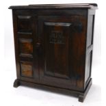 An early 18thC joined oak livery cupboard, the loose top with a moulded edge above a single panelled