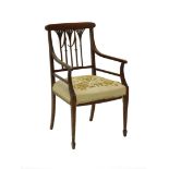 An Edwardian mahogany and satinwood open armchair, with a pierced fret work back, a padded wool work