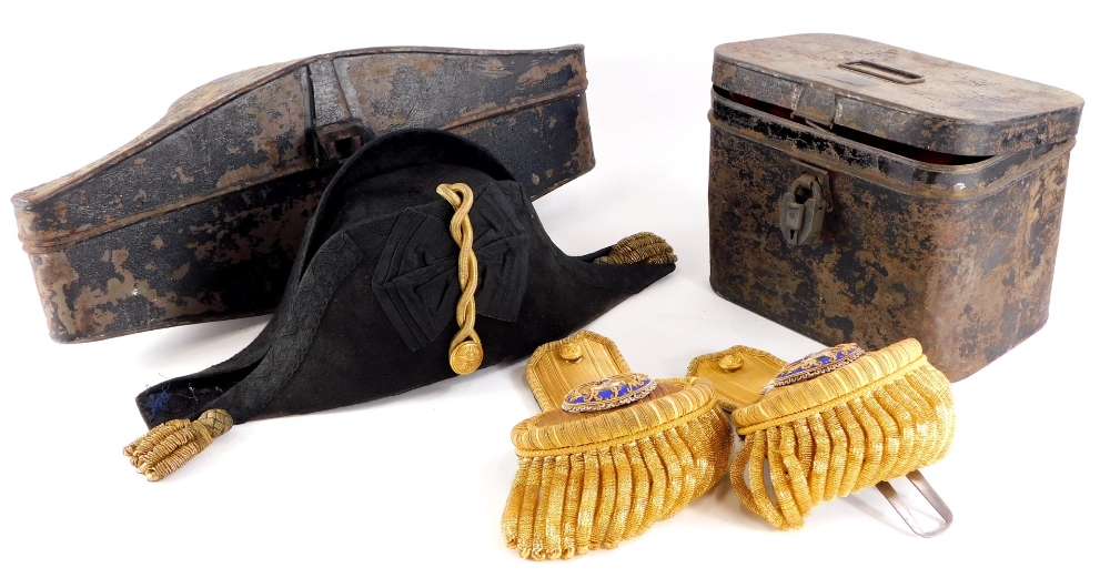 A Naval bicorn hat, with a fitted toleware case, and a pair of Epaulettes in toleware box stamped H.