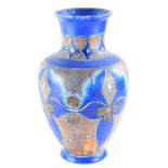 A Clews and Co Chameleon ware Art Deco vase, decorated with scrolls in brown, etc., on a blue