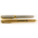 A Parker fountain pen, with a 9ct gold engine turned case, and a Parker Sonnet fountain pen. (2)