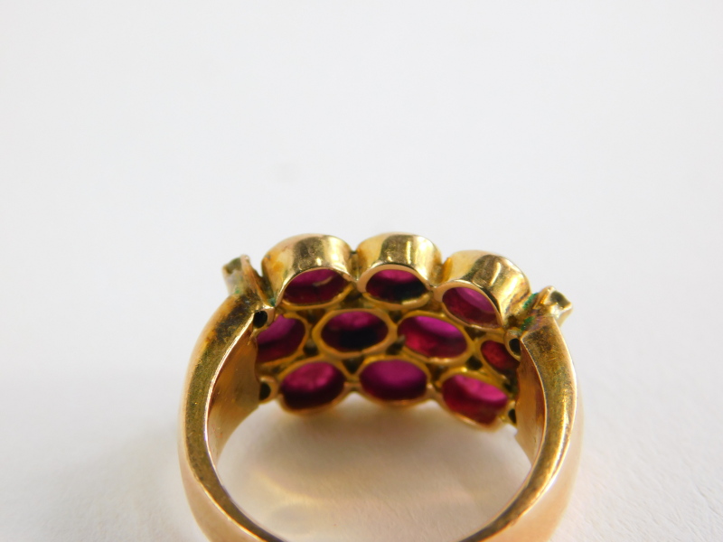 A ruby and diamond dress ring, with three rows of cabochon cut rubies and four tiny diamonds, on a - Image 2 of 2