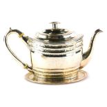 A George III Scottish silver teapot, of oval form with floral head and stylised wave decoration,
