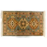 A machine woven Persian type rug, with a central pole medallion, on a pale blue ground, with