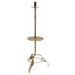 An Arts and Crafts style hammered and wrought iron candle stand, with petalated sconce and under