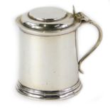 An Elizabeth II silver mustard pot, with blue glass liner, weighable silver 3½oz, 6cm high.
