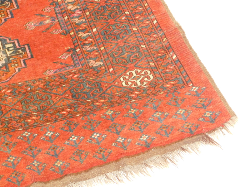 A Turkoman type rug, with a design of nine medallions on a red ground with multiple borders, 175cm x - Image 2 of 3