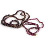 Two thin beaded necklaces, to include an Indian garnet and red and gold thread necklace of graduated