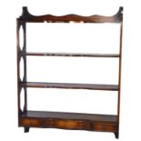 A mahogany wall shelf in George III style, with four shaped shelves, pierced end supports and