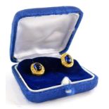 A pair of sapphire and diamond earrings, each with central cabochon cut sapphire in four claw