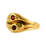 A Victorian 9ct gold dress ring, of two twist design, with two snake type heads, set with garnet