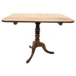 An early 19thC mahogany breakfast table, the rectangular tilt top on a turned column and tripod base