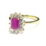 A 9ct gold ruby and diamond dress ring, with central rectangular cut ruby, in claw setting, with