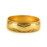 A 9ct gold wedding band, with hammered decoration borders, of three point design, ring size V½, 3g.