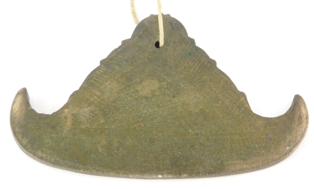 A hanging bronze implement