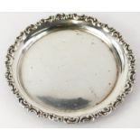A silver card tray or waiter, the border cast with scrolls, etc., indistinctly hallmarked, 5½oz,