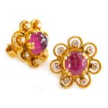 A pair of ruby and diamond cluster earrings, each set with central cabochon cut ruby with seven
