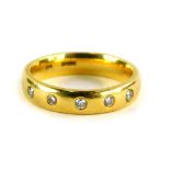 An 18ct gold diamond set half hoop dress ring, set with six illusion set tiny diamonds, ring size J,