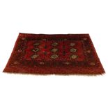 A Turkoman type rug, with a design of nine medallions on a red ground with multiple borders, 175cm x
