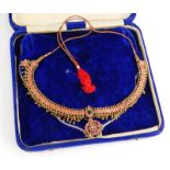 An Indian dress necklace, the necklace set with cabochon set rubies, with emerald and moon stone