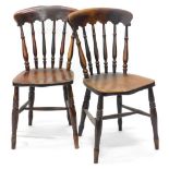 A pair of Windsor type kitchen chairs, each with a shaped back, spindle turned supports and a