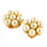 A pair of pearl earrings, each in a cluster group, with seven pearls, in a yellow clip on metal