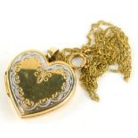 A 9ct gold heart locket pendant, on a fine link chain, the heart link pendant of two colour