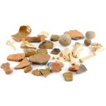 A quantity of excavated fragments of pottery, some flint balls, etc.