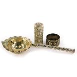 Three items of Eastern silver coloured metal, to include a sifter spoon with handle, napkin ring,
