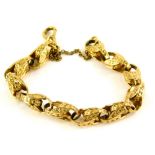 A late Victorian 9ct gold fancy link bracelet, each with oval V clip, engraved design links, with