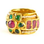 An Indian dress ring, set with various cabochon cut rubies, emeralds and seed pearls, the centre