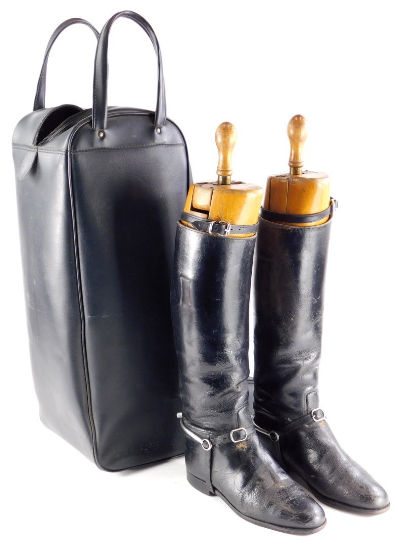 A pair of black leather riding boots, with trees in a black leatherette travelling case.