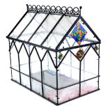 A Victorian style ebonised metal clear and coloured glass terrarium, 46cm x 29cm.
