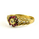 A 9ct gold dress ring, with central floral cluster set with garnets and illusion set tiny diamond,