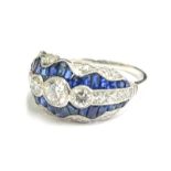 A sapphire and diamond dress ring, set with various round brilliant cut diamonds, and baguette cut