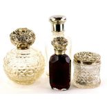 A collection of glass and silver mounted scent bottles, to include two cut glass example, a jar, and