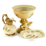 Three items of blush ivory group porcelain, a Royal Worcester centrepiece painted with flowers, on a