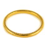 A 22ct gold thin wedding band, with rubbed etched decoration, Birmingham, ring size S, 2.6g.