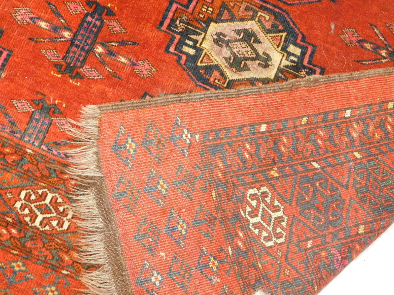 A Turkoman type rug, with a design of nine medallions on a red ground with multiple borders, 175cm x - Image 3 of 3